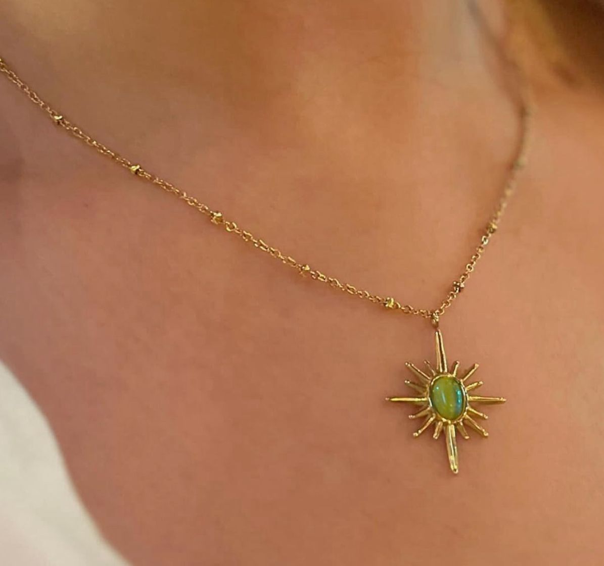 Gold Sunburst Pendant Necklace with Green Stone